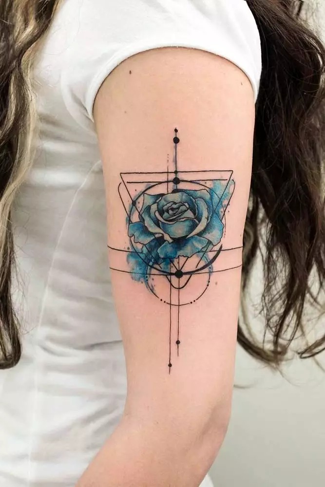 For those drawn to modern, abstract art, this blue rose tattoo incorporates geometric shapes and clean lines, making it a standout piece.
