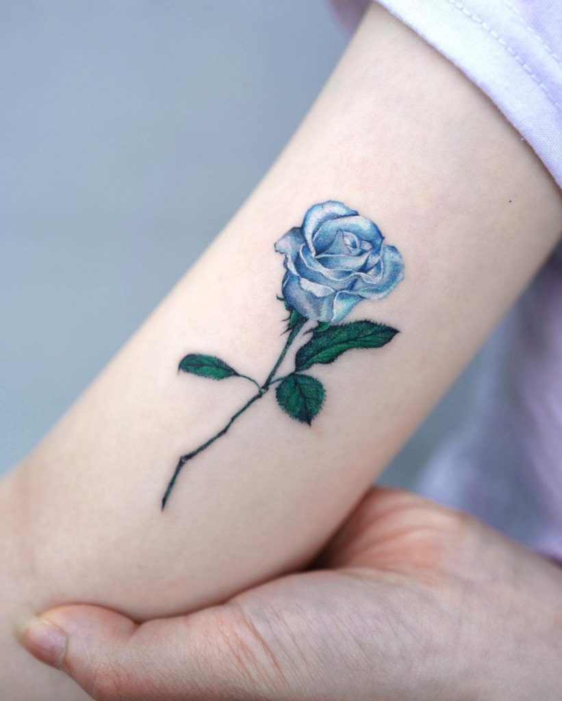 For those who appreciate simplicity, this minimalist blue rose tattoo captures elegance in its purest form.