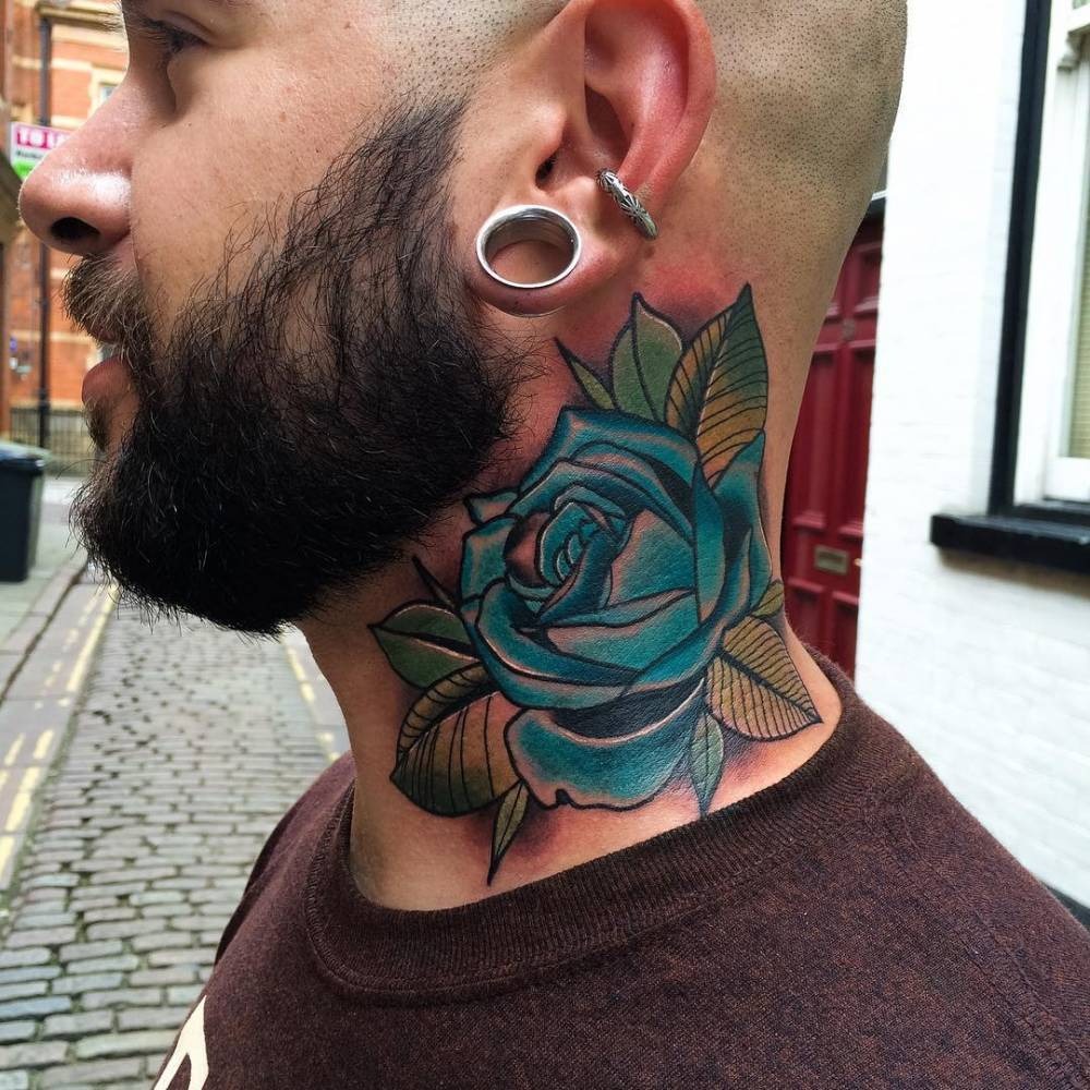 Positioned prominently on the neck, this blue rose tattoo embodies both confidence and artistry.