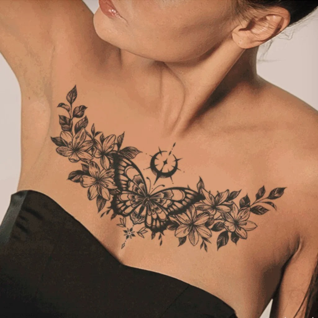This tattoo combines a hand-crafted style with strong black lines, bringing the floral and butterfly motif to life on the chest.