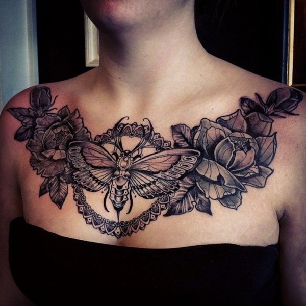 This tattoo combines a moth in the center with lush floral arrangements extending across both collarbones.