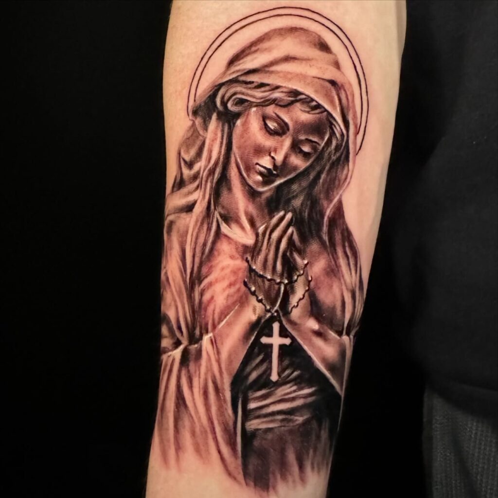 Virgin Mary Hand Tattoo with Radiant Halo Tattoo Design
