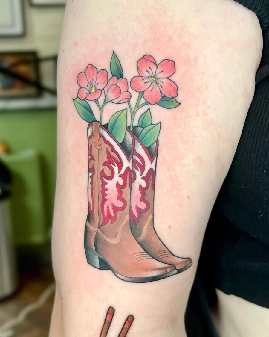 Charming tattoo featuring boots and blossoms Tattoo Design