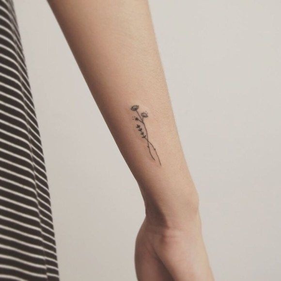 The lotus blossom is a powerful symbol of purity, growth, and enlightenment, and this small tattoo captures its essence with minimalist lines and a simple, elegant design.