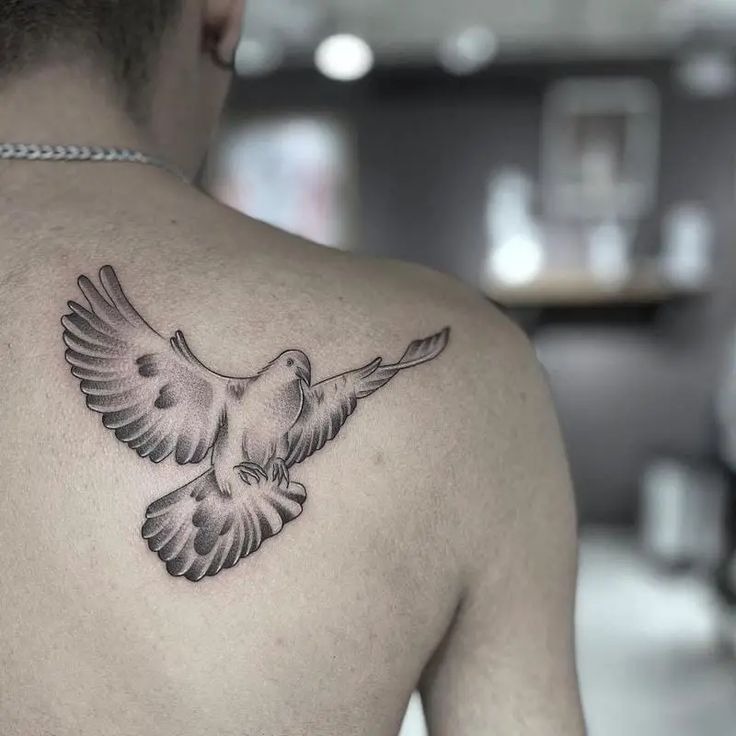 Graceful Back Dove: Strength in simplicity Tattoo Design