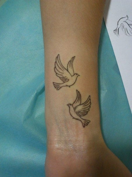 Pair of doves in flight (wrist) Tattoo Design
