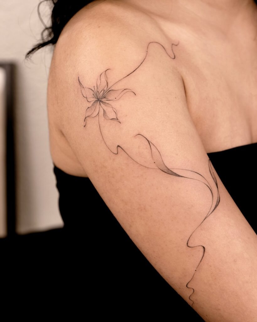 Elegant Fine Line Flower on Shoulder and Arm Tattoo Design