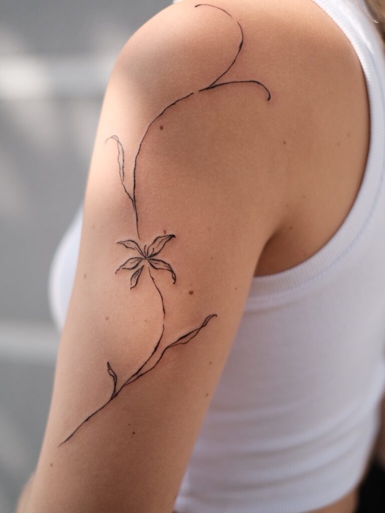 Fine Line Floral Tattoo with Flowing Stems on Arm Tattoo Design