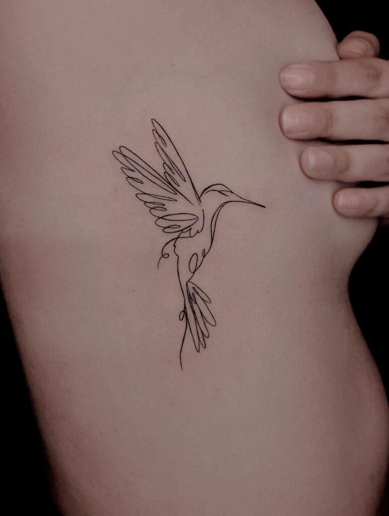 Fine Line Hummingbird Tattoo on Ribcage Tattoo Design