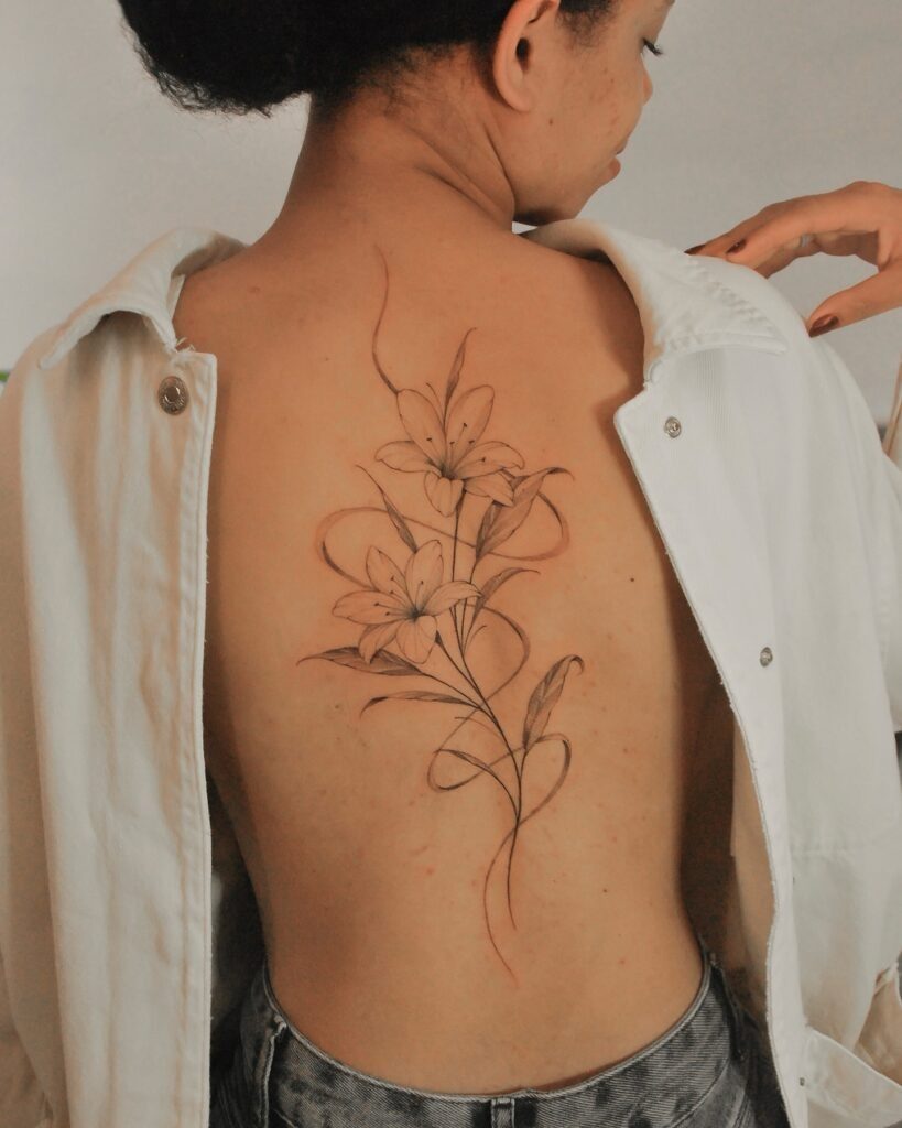 Fine Line Lily Tattoo on Back Tattoo Design