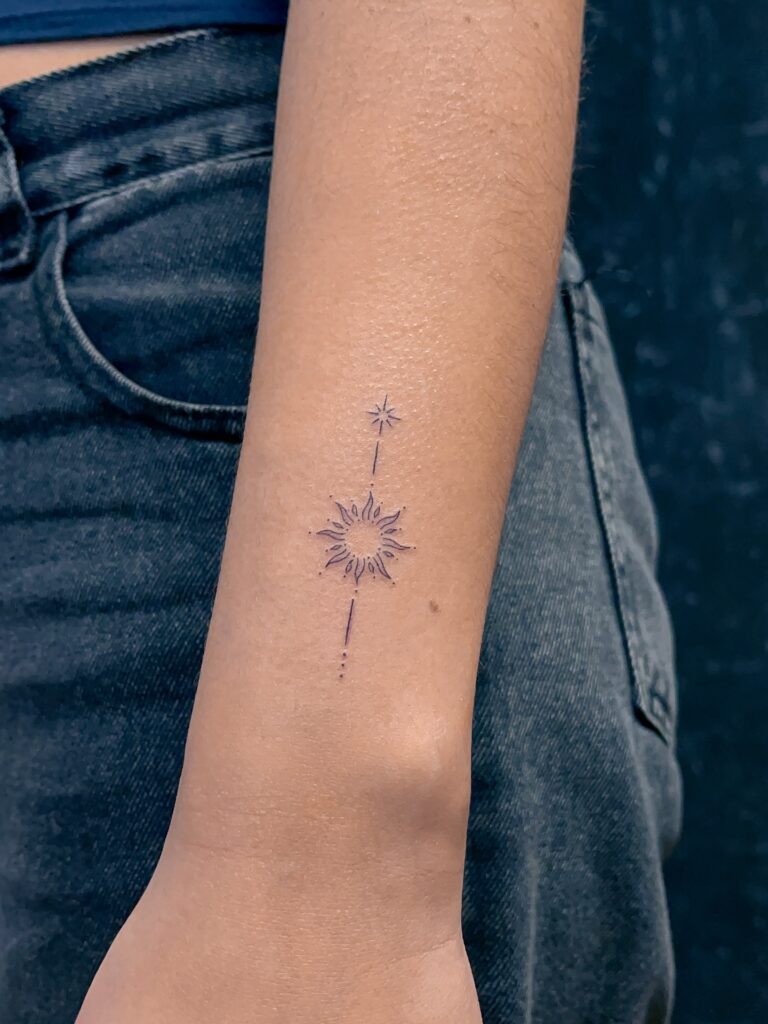 Minimal Fine Line Sun and Star Tattoo on Arm Tattoo Design