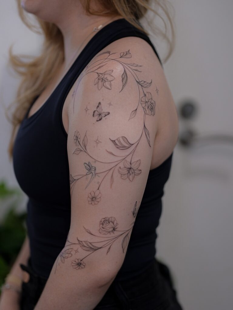 Whimsical Floral and Butterfly Sleeve Tattoo Tattoo Design