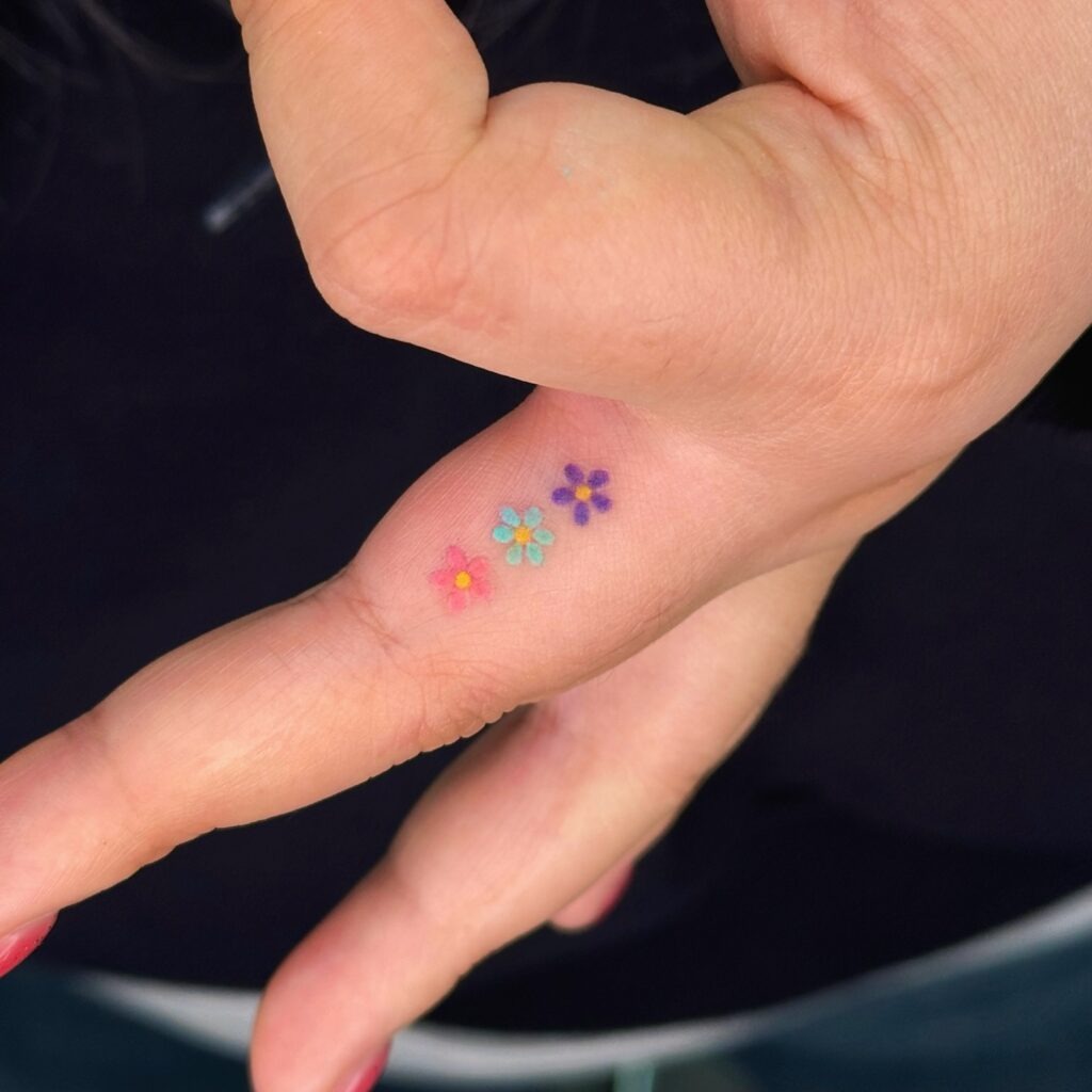 Colorful Tiny Flower Finger Tattoo Tattoo Design