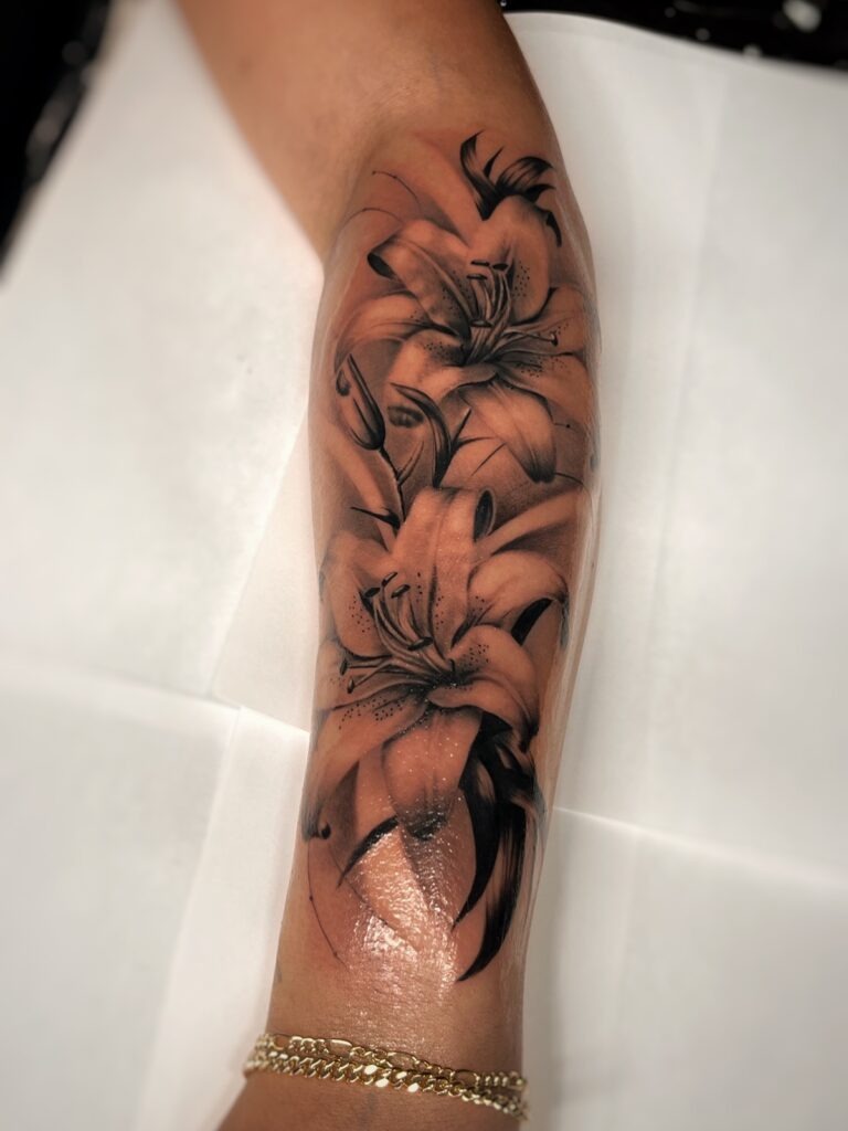 Lily Half Sleeve Tattoo in Black and Grey Shading Tattoo Design