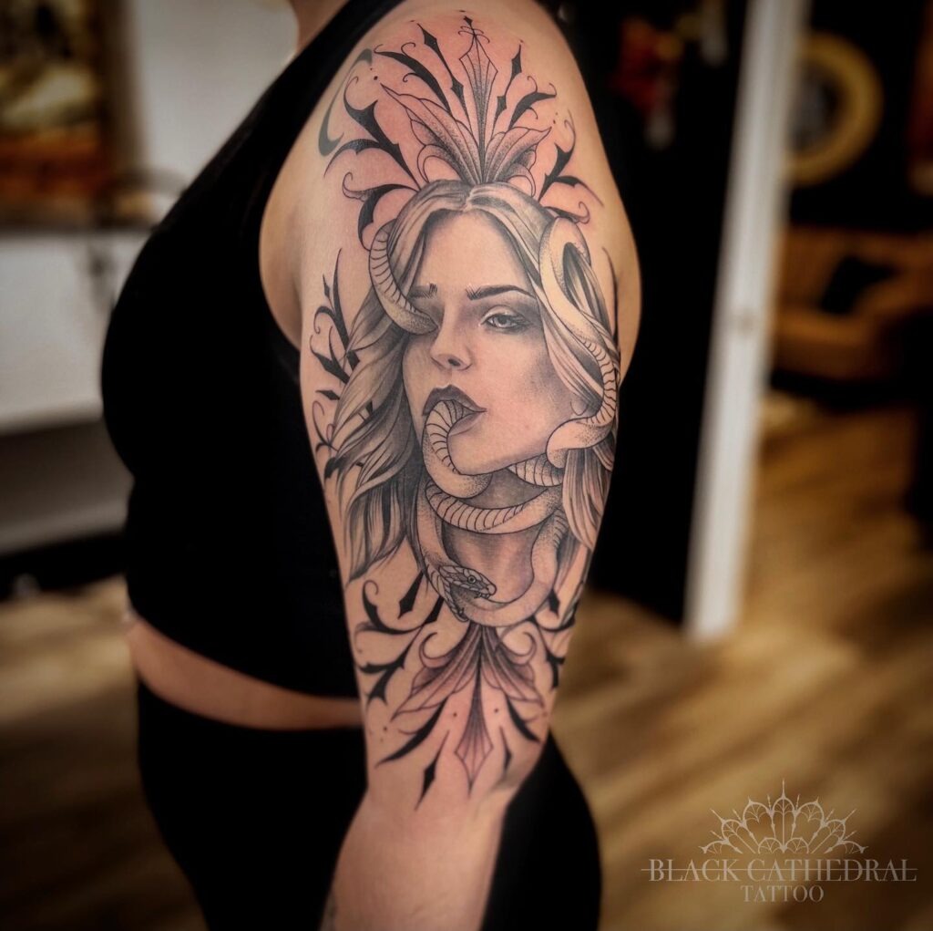 Medusa-Inspired Half Sleeve Tattoo with Serpent and Woman’s Portrait Tattoo Design