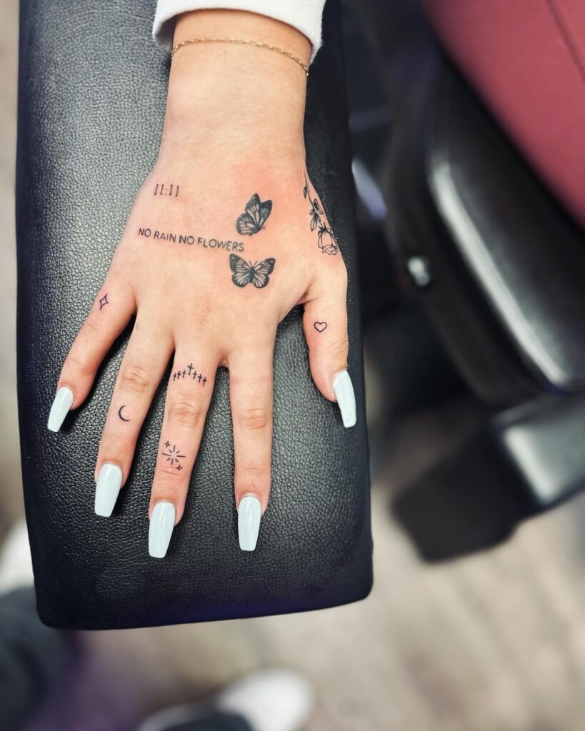 Butterfly and Cosmic Stars Hand Tattoo Tattoo Design