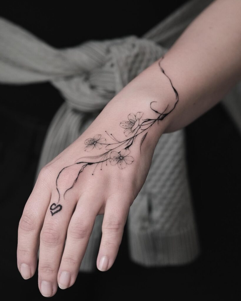 Delicate Floral and Celestial Hand Tattoo Tattoo Design