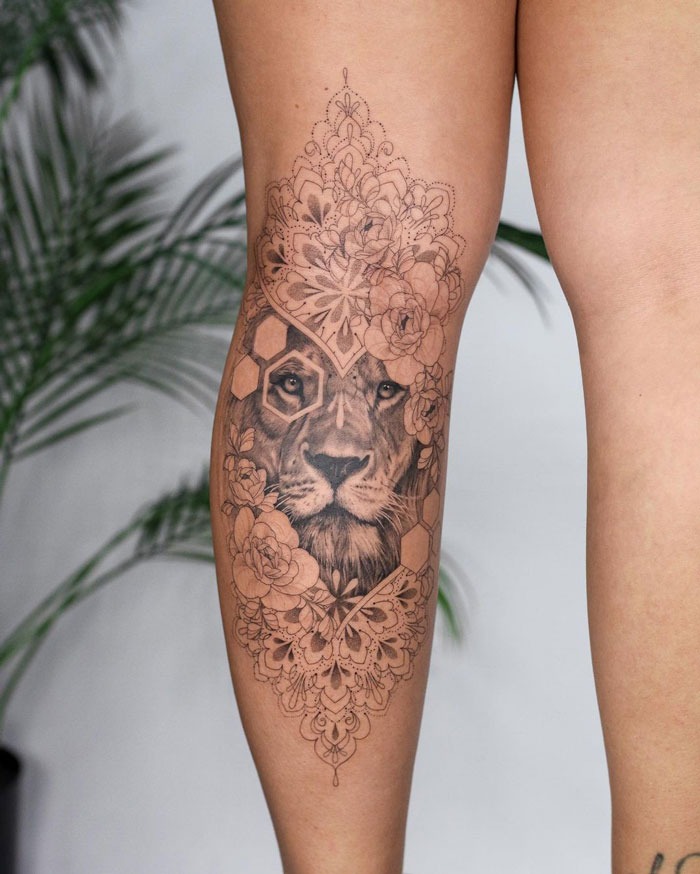 Lion and Floral Medley on the Upper Leg Tattoo Design