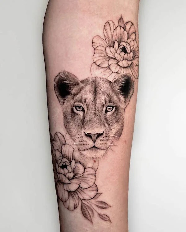 Fierce Lioness Tattoo with Floral Accents Tattoo Design