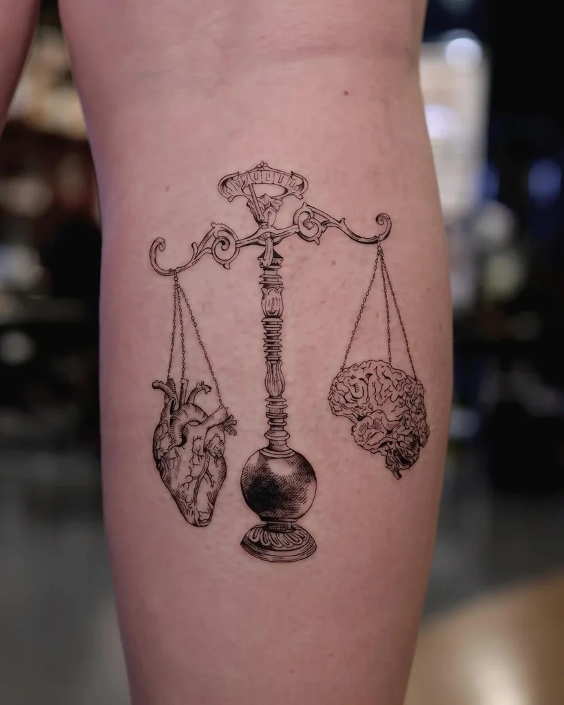 An intelligent twist on Libra's scales, this tattoo features a brain on one side and a heart on the other, representing the delicate balance between logic and emotion.