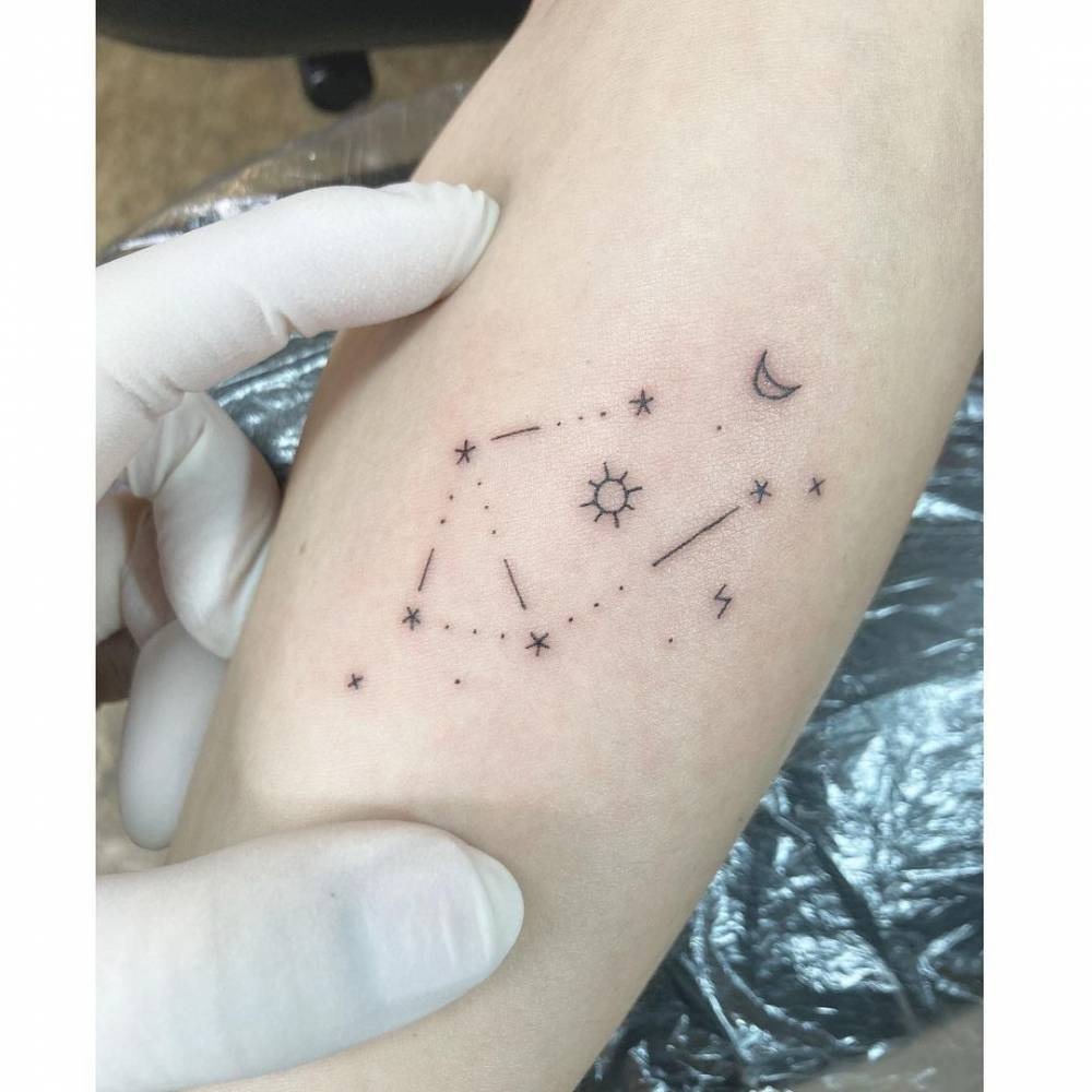 This minimalist constellation tattoo captures the essence of the Libra sign through small dots and lines, symbolizing the stars.