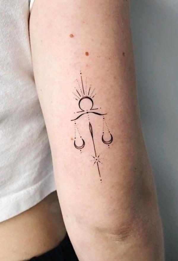 Combining solar imagery with the Libra scales, this tattoo represents the warmth of life balanced with fairness and justice.