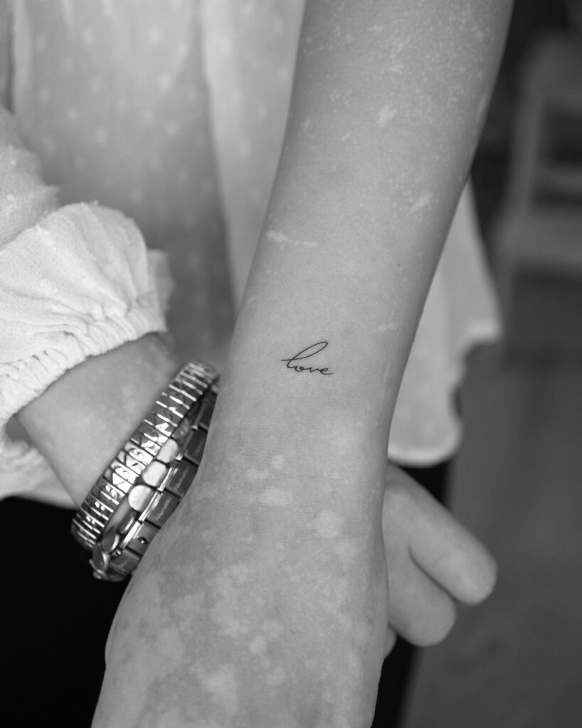 Simple Love Script Tattoo on Wrist Tattoo Design