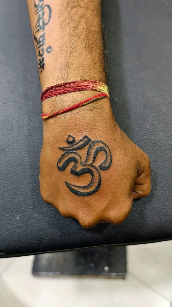 Om With Single-Line Face Motif Tattoo Design