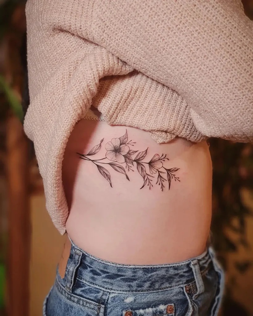 Elegant Floral Vine Along the Ribs Tattoo Design