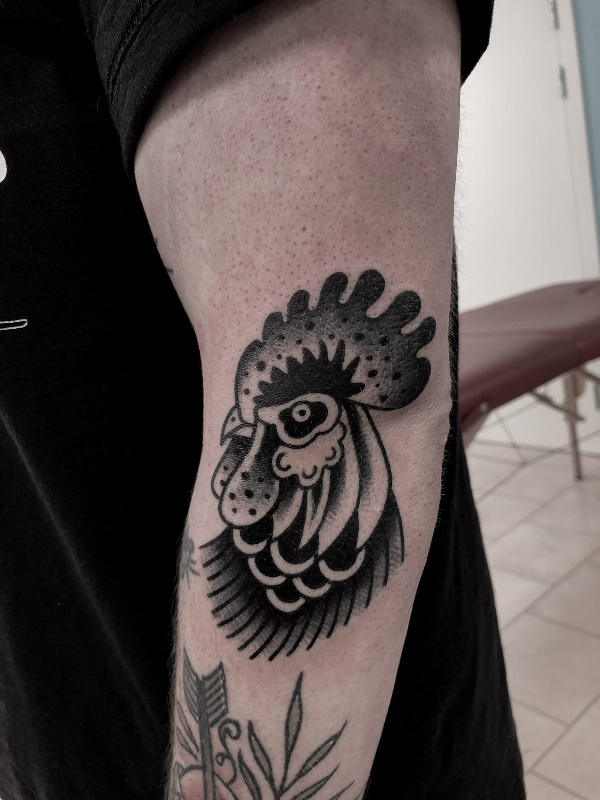 Bold Black Rooster Head On The Forearm Tattoo Design