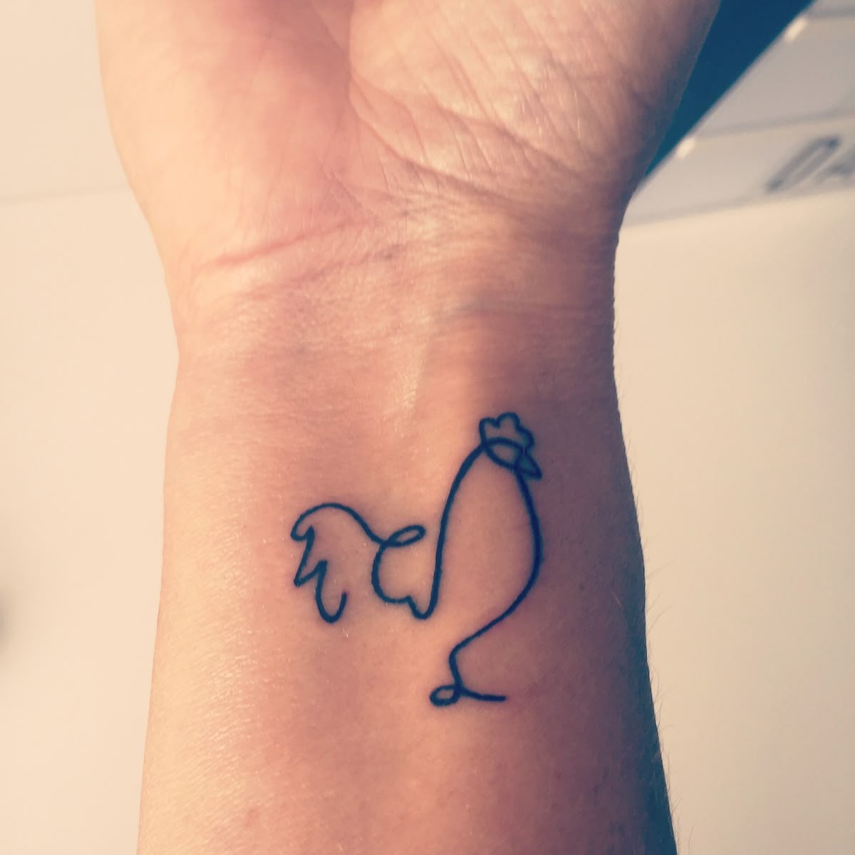 One-Line Rooster Wrist Sketch Tattoo Design
