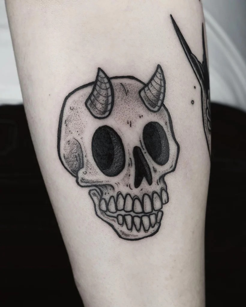 Delicate Skull with Flower Accent Tattoo Design