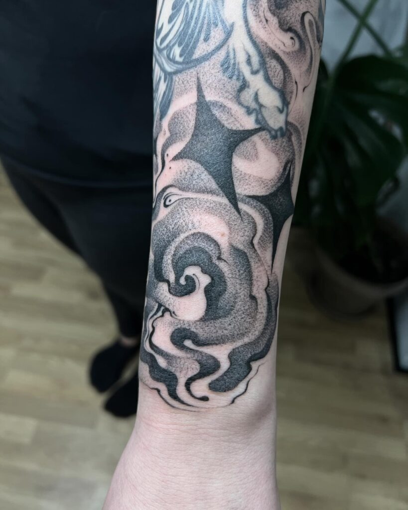 Smoky Swirl and Starburst Sleeve Filler Tattoo Design