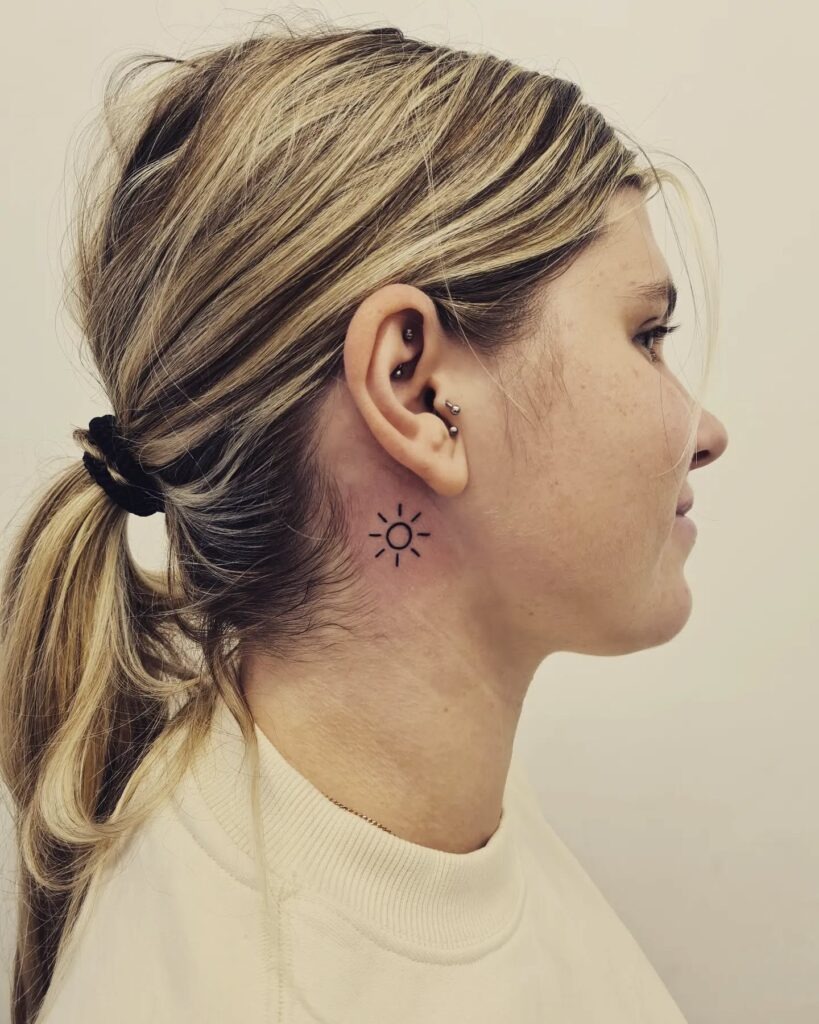 Minimal Sun Behind the Ear Tattoo Design