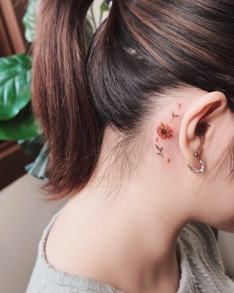 Tiny Orange Daisy Behind Ear Tattoo Tattoo Design