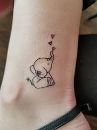 This adorable baby elephant tattoo features a cute, minimal design, perfect for someone looking for a small yet meaningful piece of ink.