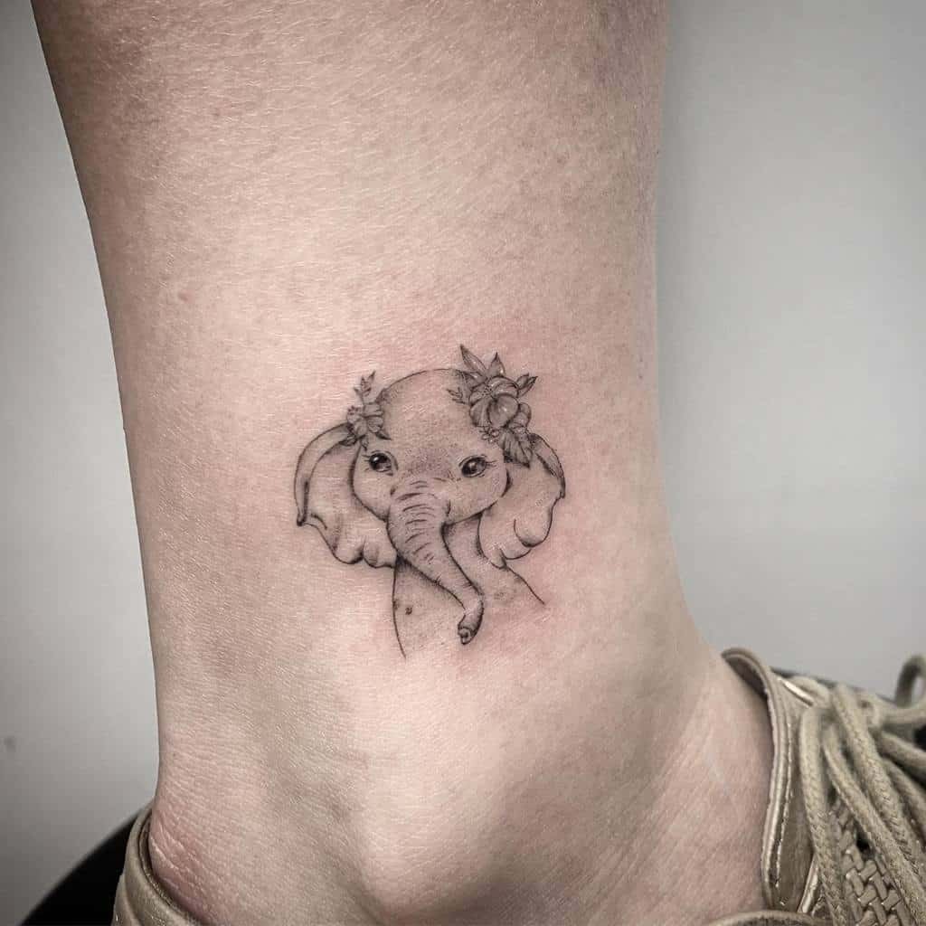 This unique and whimsical elephant tattoo showcases a baby elephant adorned with a delicate flower crown.