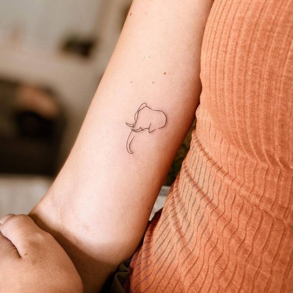 For those who appreciate clean, minimal designs, this elegant elephant outline tattoo is perfect.