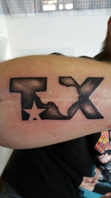 This is the kind of Texas tattoo that feels modern, clean, and a little bit badass, like you're saying what you mean with two letters and a star.