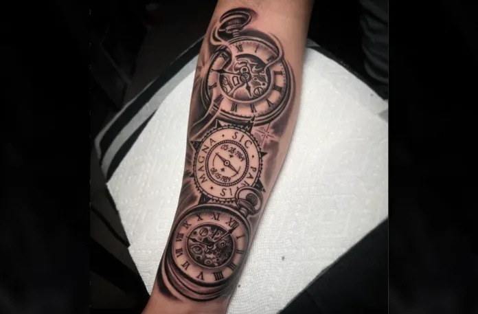 This forearm tattoo showcases a detailed pocket watch design with bold Roman numerals, symbolizing elegance and the eternal passage of time.