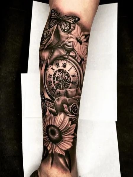 This full sleeve tattoo features a stunning combination of a detailed clock, blooming flowers, and a delicate butterfly.