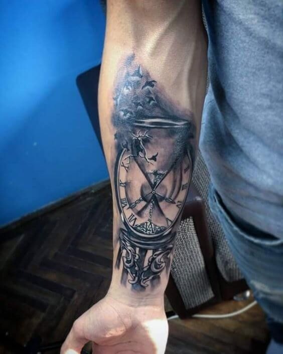 A clean, minimalist hourglass tattoo with birds escaping into the distance.