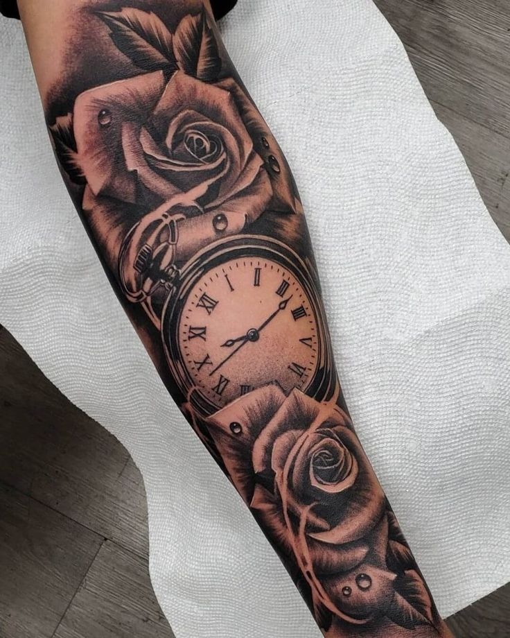 This tattoo features a vintage pocket watch surrounded by blooming roses.