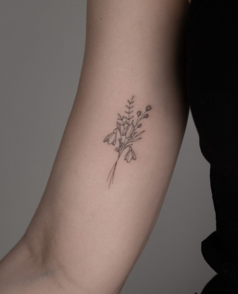 Minimalist Wildflower Bouquet Upper Arm Tattoo Tattoo Design