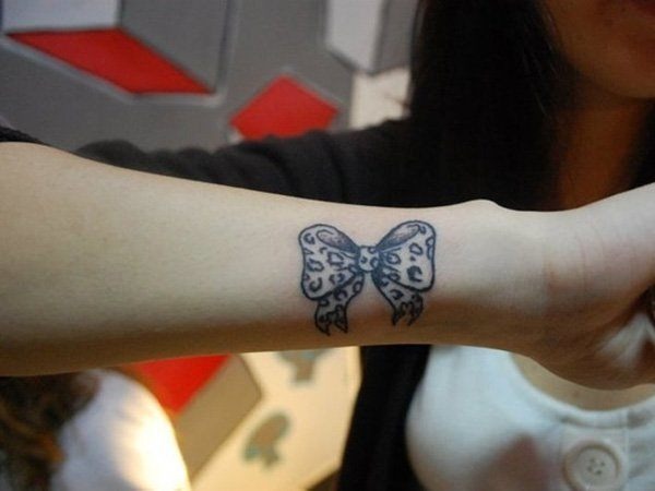 Girlie WristBow and Arrow Tattooson the arm of a Woman Tattoo Design