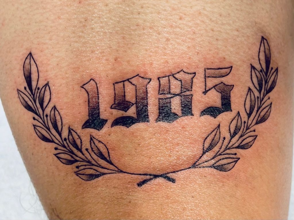 1985 with Laurel Wreath Design Tattoo Design