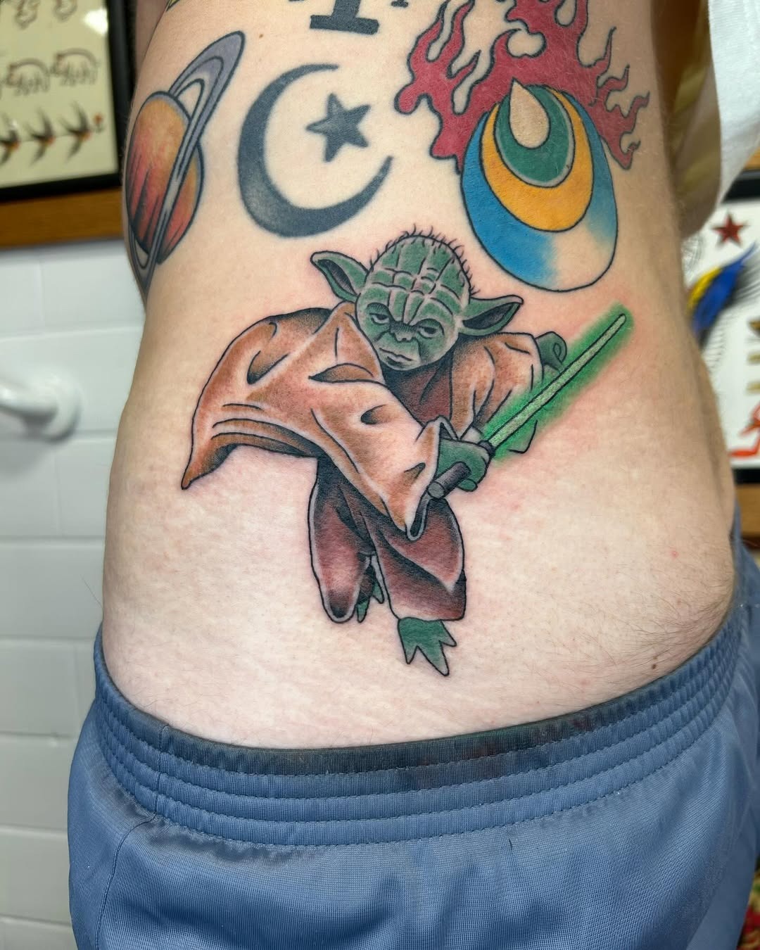 Dynamic Yoda Tattoo with Lightsaber Action Tattoo Design