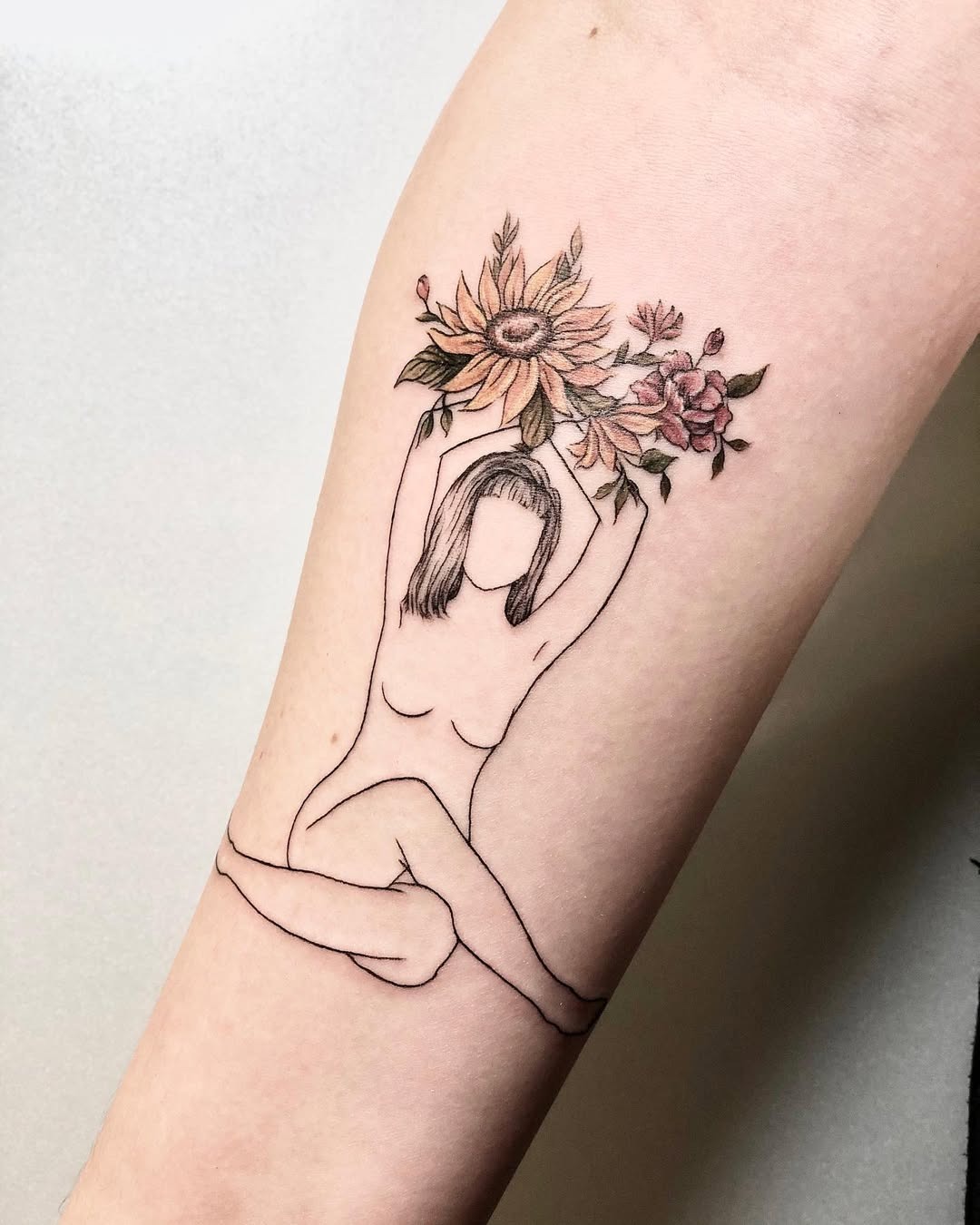 Elegant yoga silhouette adorned with colorful flowers Tattoo Design