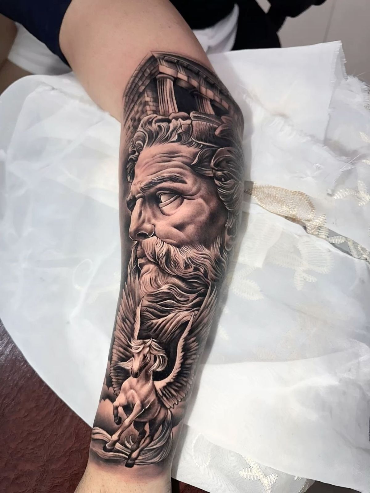 Atlas-Inspired Zeus Sleeve Tattoo Design