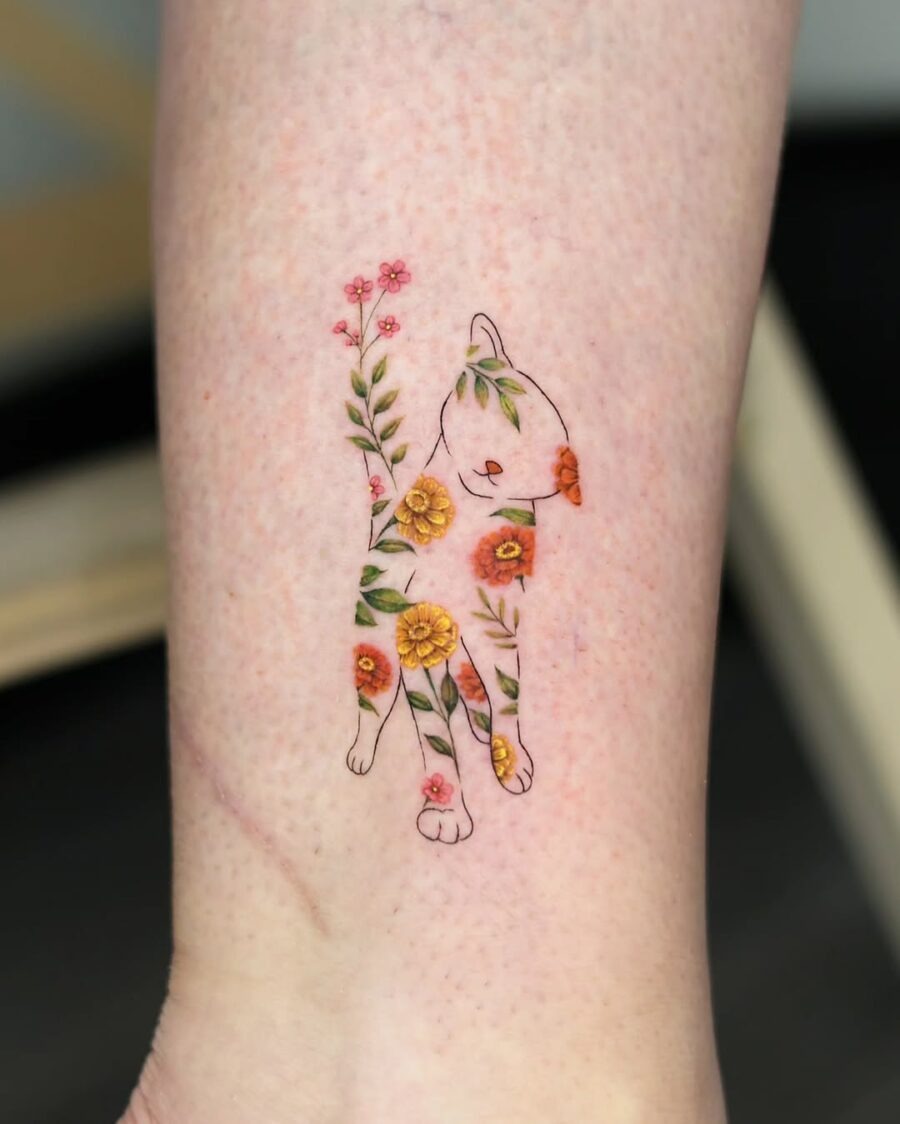 A playful cat adorned with zinnia flowers Tattoo Design